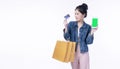 Excited smile Asian woman holding shopping bag show credit card using smartphone payment banking shopping online. Happiness lady Royalty Free Stock Photo