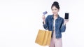 Excited smile Asian woman using mobile phone holding shopping bag show credit card payment banking shopping online. Happiness lady Royalty Free Stock Photo
