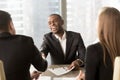 Excited smiling black businessman handshaking white partner at m Royalty Free Stock Photo