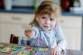 Excited smiling cute toddler girl playing picture card game. Happy healthy child training memory, thinking. Creative Royalty Free Stock Photo