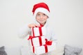 Excited smiling little boy in red santa hat with gift many boxes isolated on white background, banner copy space. Christmas Royalty Free Stock Photo