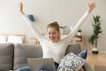 Excited smiling woman celebrating online win, using laptop at home Royalty Free Stock Photo