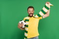 excited soccer fan in striped scarf