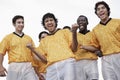 Excited Soccer Players Celebrating Victory Against Sky Royalty Free Stock Photo