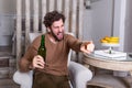 Excited sports fan sitting in an sofa and watching a match on television. leisure, sport, entertainment and people concept - man Royalty Free Stock Photo