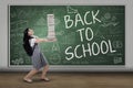 Excited student carrying many books Royalty Free Stock Photo