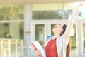 Excited student celebrating good grades in a college Royalty Free Stock Photo