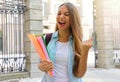 Excited student girl raising fist up celebrating outdoors Royalty Free Stock Photo