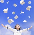 Excited student girl throwing books fly in the air Royalty Free Stock Photo