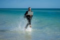 Excited summer business travel. Freelance work, online working. Summer businessman in suit run in sea water. Freelance Royalty Free Stock Photo