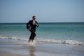 Excited summer business travel. Freelance work, online working. Summer businessman in suit run in sea water. Freelance Royalty Free Stock Photo