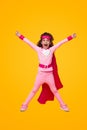 Excited superhero kid celebrating victory with raised arms