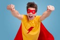 Excited superhero man flying on blue background Royalty Free Stock Photo