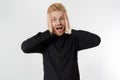 Excited surprised shock young shouting man isolated on gray background. Happy Redhead guy with red beard in black stylish shirt.