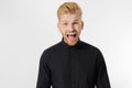 Excited surprised shock young shouting man isolated on gray background. Happy Redhead guy with red beard in black stylish shirt.