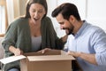 Excited surprised woman looking into cardboard box, receive parcel Royalty Free Stock Photo