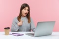 Excited surprised woman office worker pointing herself and looking at laptop screen with amazed expression, talking on video call Royalty Free Stock Photo