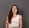 Excited surprising funny business woman with open mouth and big eyes looking up in glasses in white t- shirt  on empty copy space Royalty Free Stock Photo
