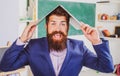 Excited teacher professor with laptop on head wearing formal suit with funny expression emotions funny face. Royalty Free Stock Photo