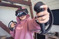 Excited teen hipster girl playing virtual reality video game wear vr goggles.