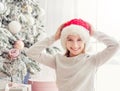 Excited teenage girl near christmas tree