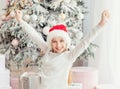 Excited teenage girl near christmas tree