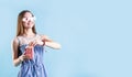 Excited female teenager girl wearing 3D glasses eating popcorn isolated on blue background Royalty Free Stock Photo