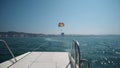 Excited tourists parasailing high in the sky