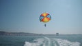 Excited tourists parasailing high in the sky, extreme sport