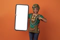 Excited traditional african woman holding huge smartphone, mockup