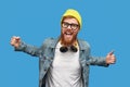 Excited trendy guy dancing and looking at camera Royalty Free Stock Photo