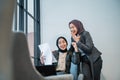 happy muslim businesswoman raise their arm while looking at the business report