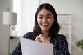 Happy Vietnamese girl smile reading paper letter