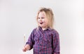 Excited wide eyed female child wearing plaid shirt yelling with flaming match Royalty Free Stock Photo