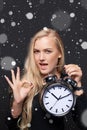 Excited woman with big alarm clock gesturing OK sign Royalty Free Stock Photo