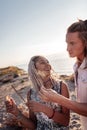 Cheerful woman with dreadlocks feeling excited before lightening sparklers