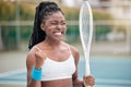 Excited woman cheering after a tennis match. Young tennis player enjoying a game of tennis on the club court. African Royalty Free Stock Photo