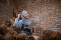 excited woman craftswoman wearing a hijab while using a tablet Royalty Free Stock Photo