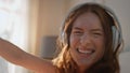 Excited woman dancing headphones in sunlight closeup. Energetic female listening