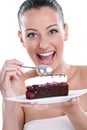 Excited woman eating tasty cakes