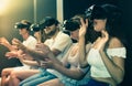 Excited woman is experiencing with friends virtual reality