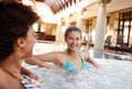 Excited woman, friends and laughing with jacuzzi for funny joke or humor at hotel, resort or hot tub spa together. Happy Royalty Free Stock Photo
