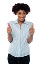 Excited woman gesturing double thumbs up