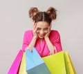 Excited woman holding colourful shopping bags in studio Royalty Free Stock Photo