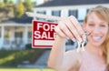 Excited Woman Holding House Keys and For Sale Real Estate Sign i Royalty Free Stock Photo