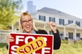 Excited Woman Holding House Keys and Sold Real Estate Sign Royalty Free Stock Photo