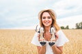Excited woman holding new shoes that she found on sale Royalty Free Stock Photo