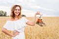 Excited woman holding new shoes that she found on sale Royalty Free Stock Photo