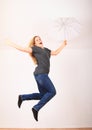 Excited woman jumping or flying with white umbrella Royalty Free Stock Photo