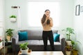 Young woman feeling excited while singing in the living room